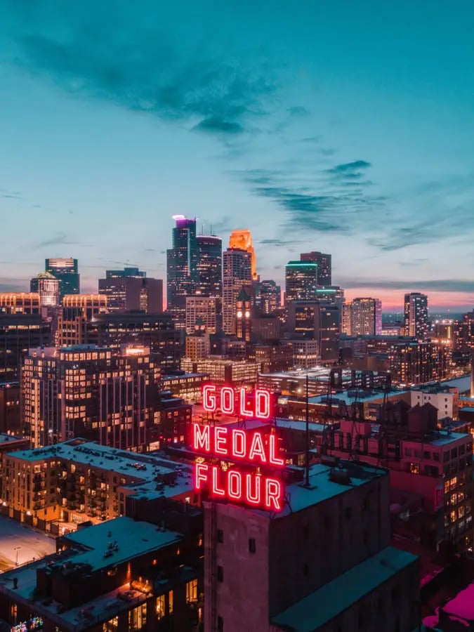 Minneapolis skyline at sundown with Gold Medal Flour neon sign in forefront