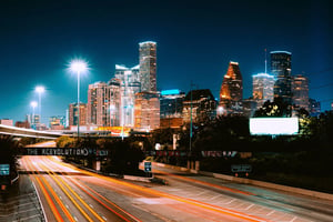Houston cityscape at night with highway in foreground
