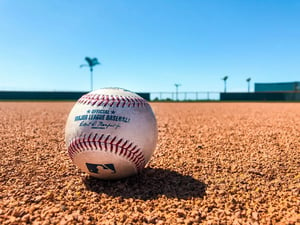 close up of MLB baseball on brown dirt