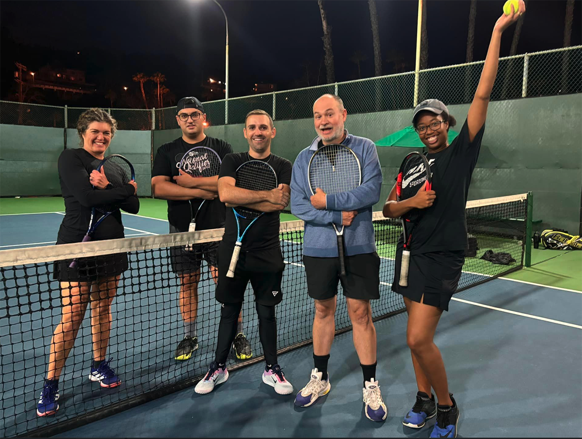 A group of tennis players on the court