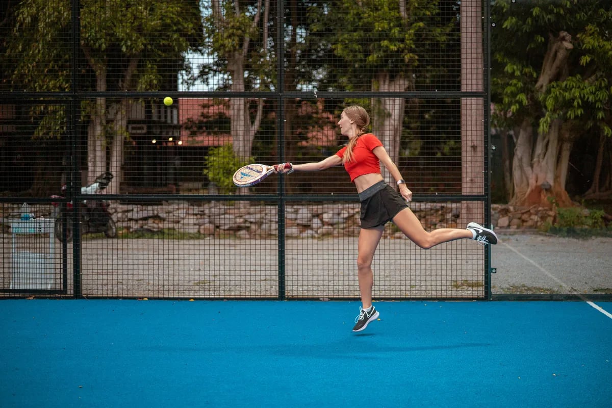 woman about to hit ball on padel court
