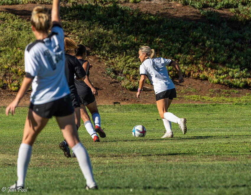 female soccer player preparing to kick ball in game