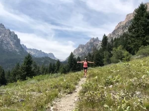 Hiking trail with mountain in backgrounds and Cammas Freeman on the trail