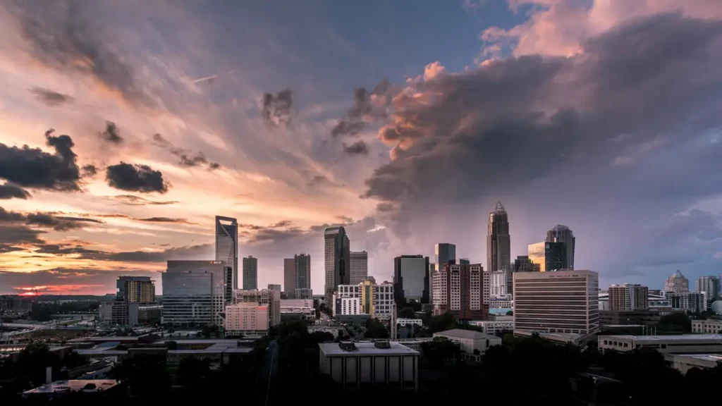 Charlotte skyline at sunrise with dark clouds