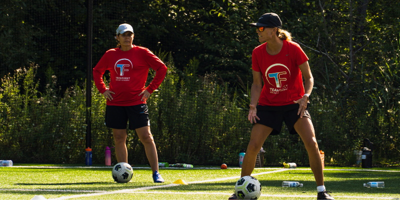 women's soccer legends mia hamm and tina hoch on field