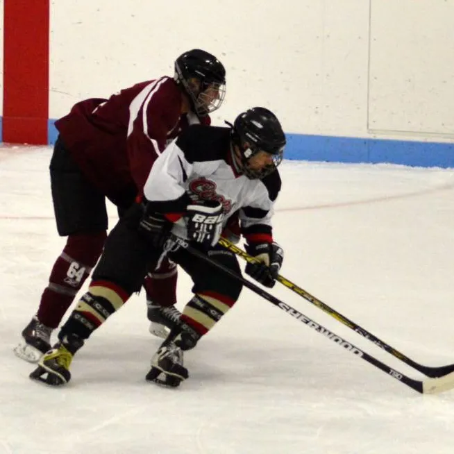 beer league hockey two players on ice