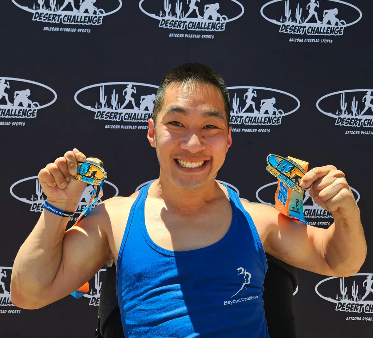 athlete steve f holding medals
