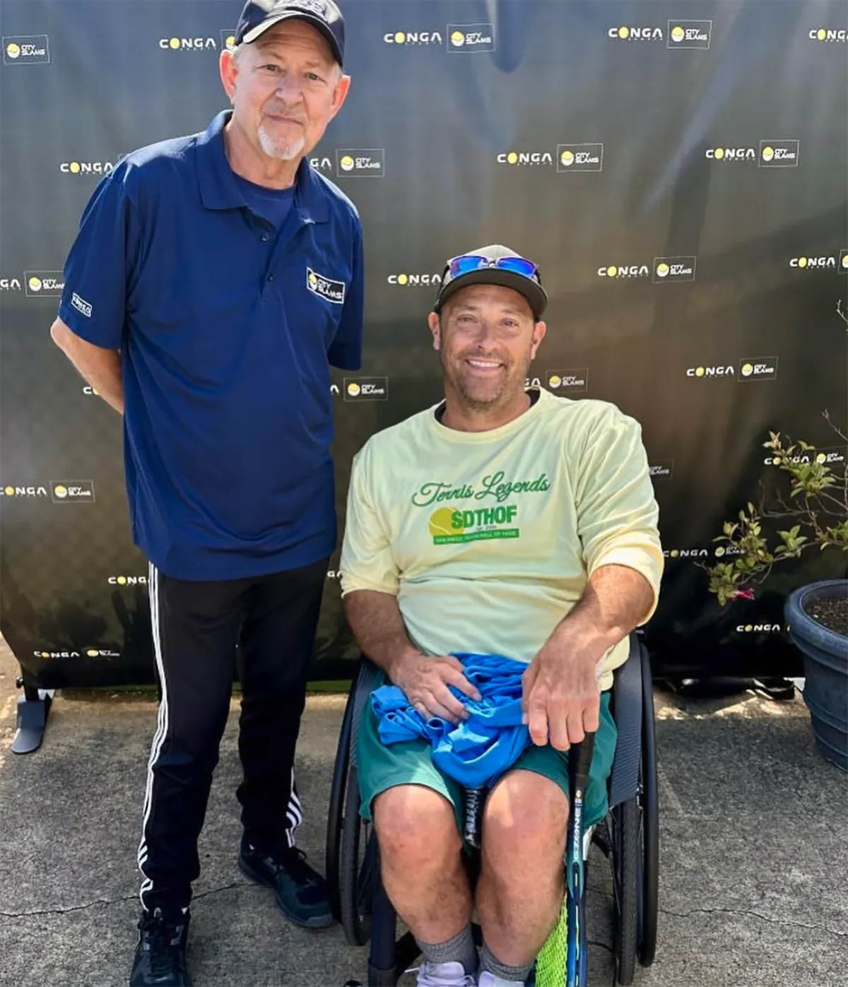 Rich Neher and David Wagner, wheelchair tennis player, posing for a pic