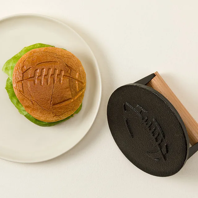 overhead view of burger with football imprint in the bun