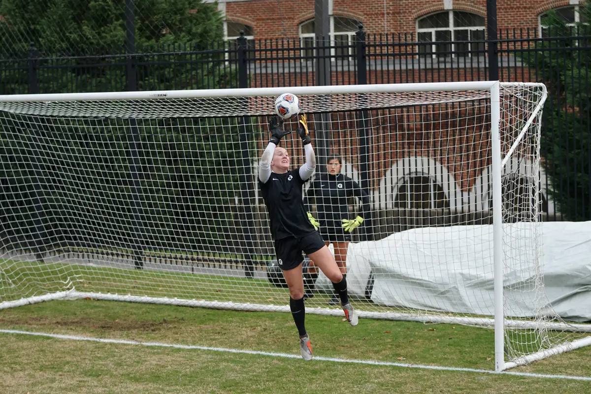 female goalie outstretched saving a ball